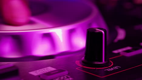 dj with headphones and sunglasses playing music on festival in night club. techno musician performing at nightclub for concert crowd of people, city bar.
