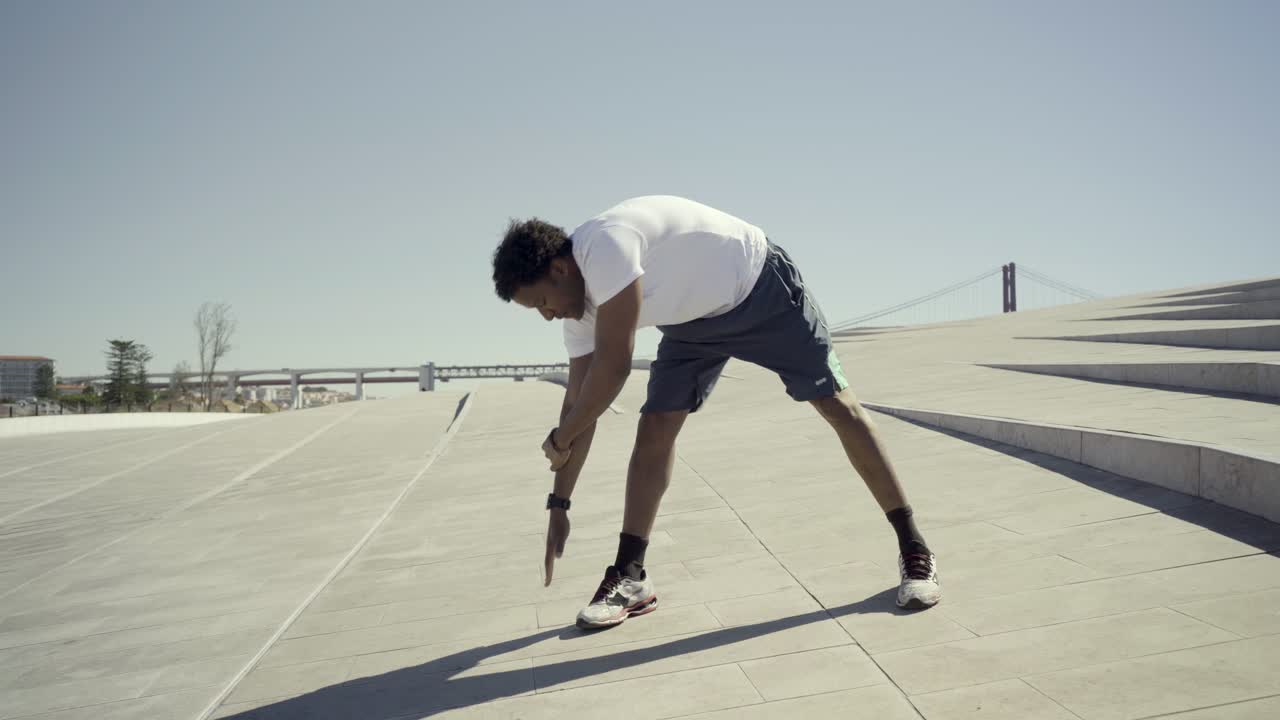 Handsome African American man warming up outdoor.