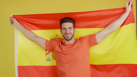 man proudly displaying the spanish flag