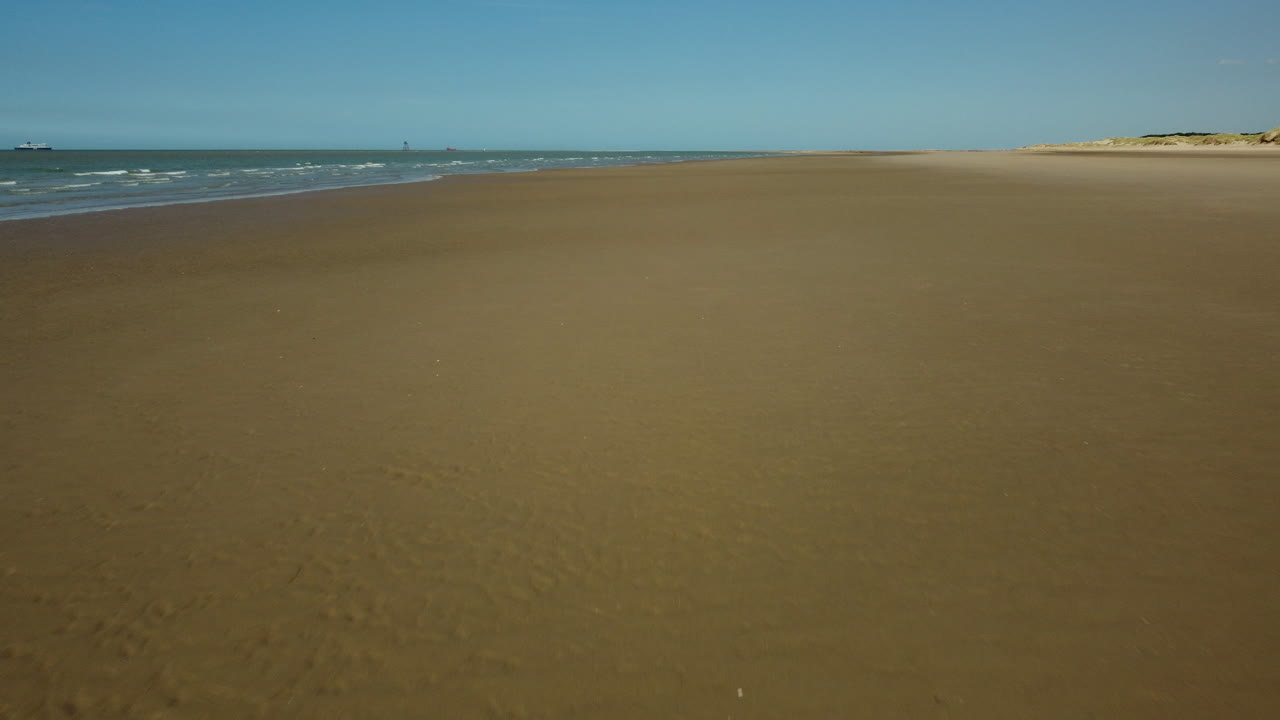 Beach Drone Shot with Man and Bicycle