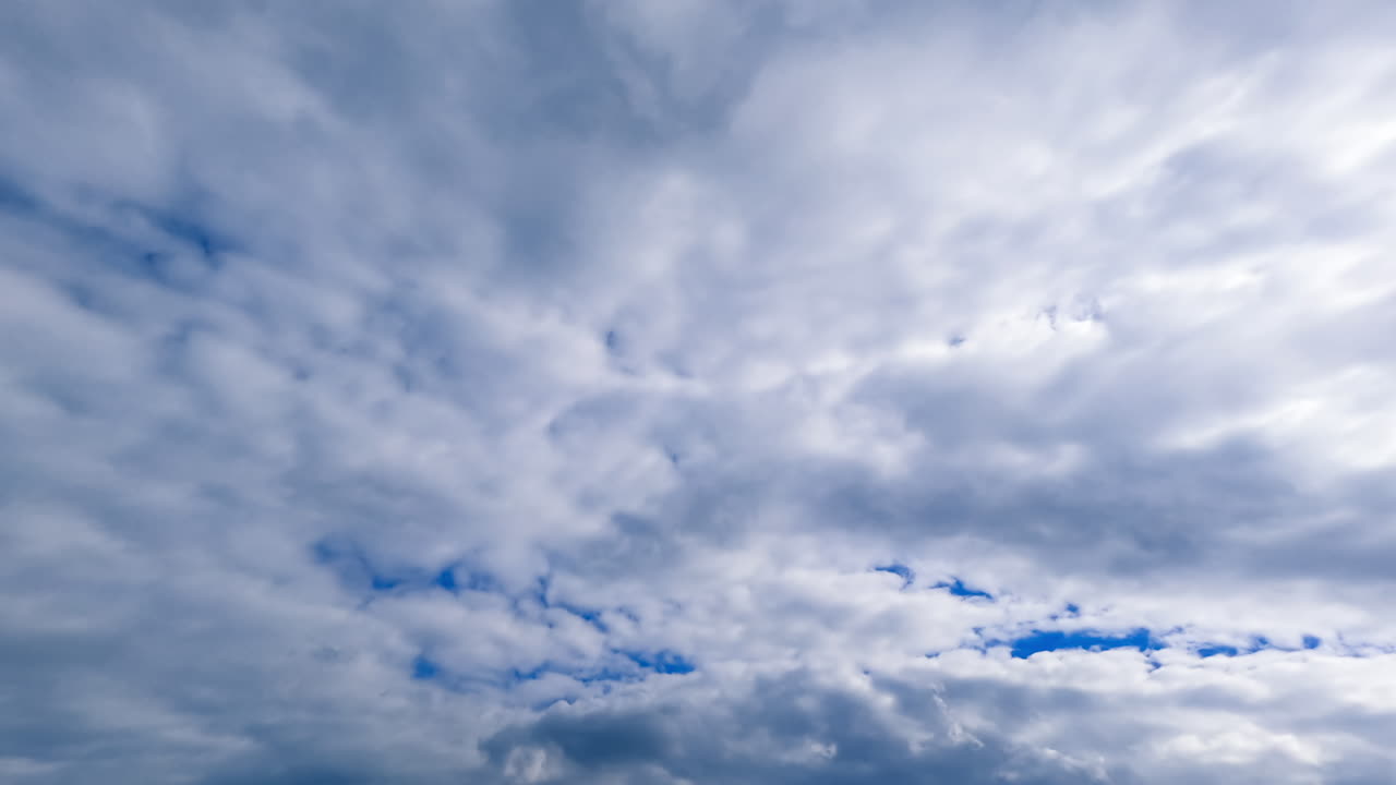 Grey massive cloudscape covering the horizon. Sky cannot be seen as the clouds spread all over it. Low angle view. Timelapse.