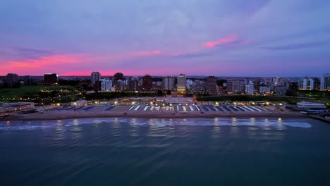 aerial shot of mar del plata playa grande beachfront at vibrant sunset, argentina