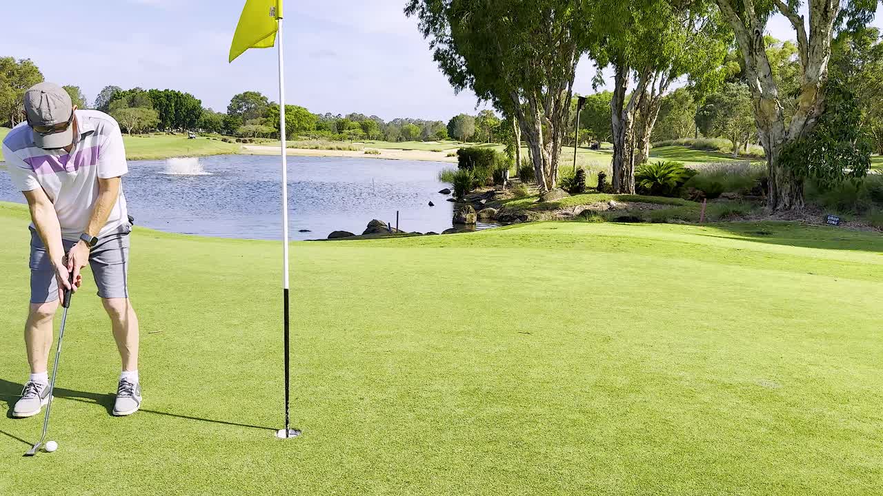 골퍼가 물에 의해 이 좋은 날을 보내고 있습니다.