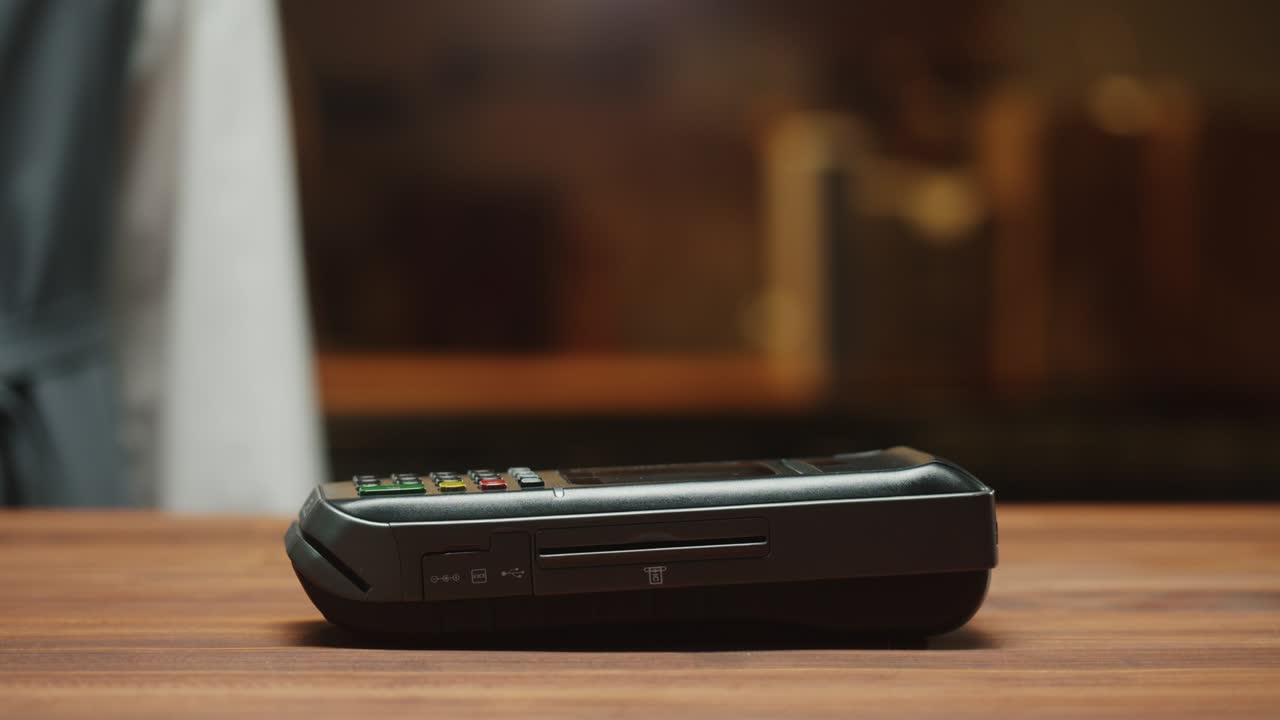Paying by smartphone with chroma green screen close-up. Cashless shopping in restaurant or cafe. Touch-free and contactless payment concept. NFC technology and bank terminal.