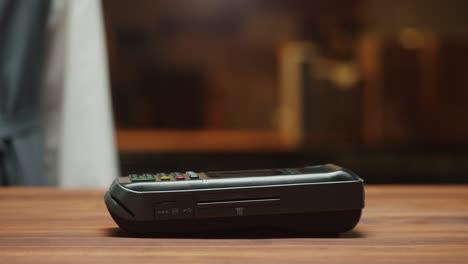 paying by smartphone with chroma green screen close-up. cashless shopping in restaurant or cafe. touch-free and contactless payment concept. nfc technology and bank terminal.