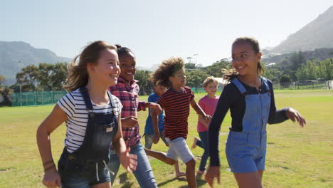 six friends running in a park, tracking shot, close up