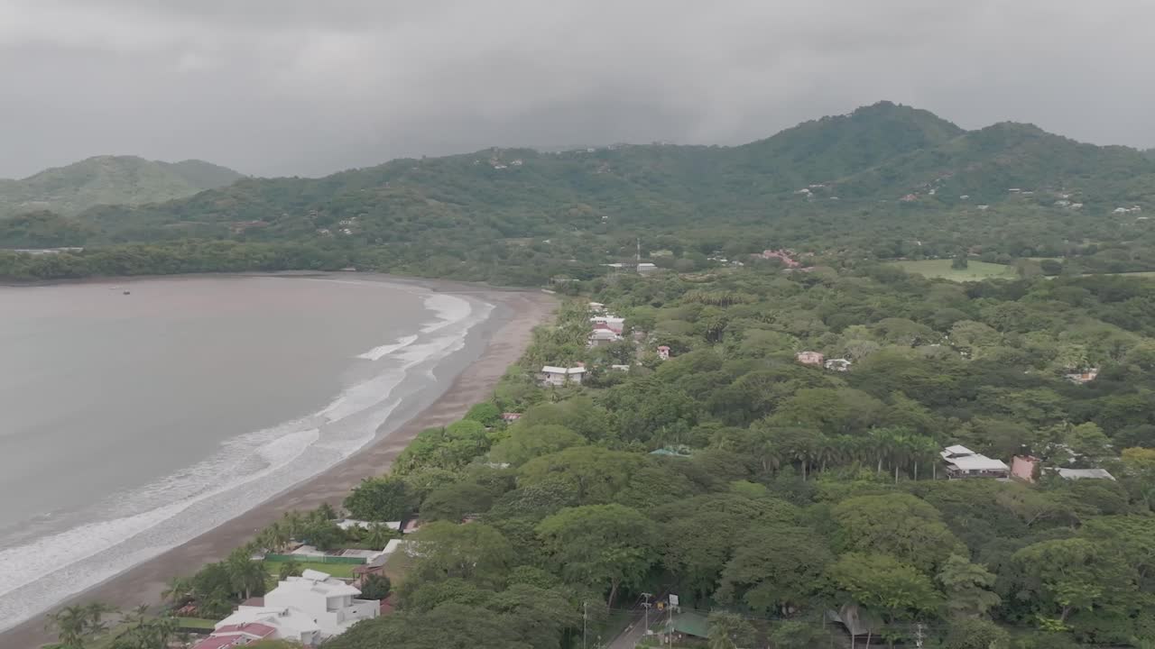 Playa Potrero in Costa Rica with beach view, beach houses and Pacific Ocean view and drone video moving right to left