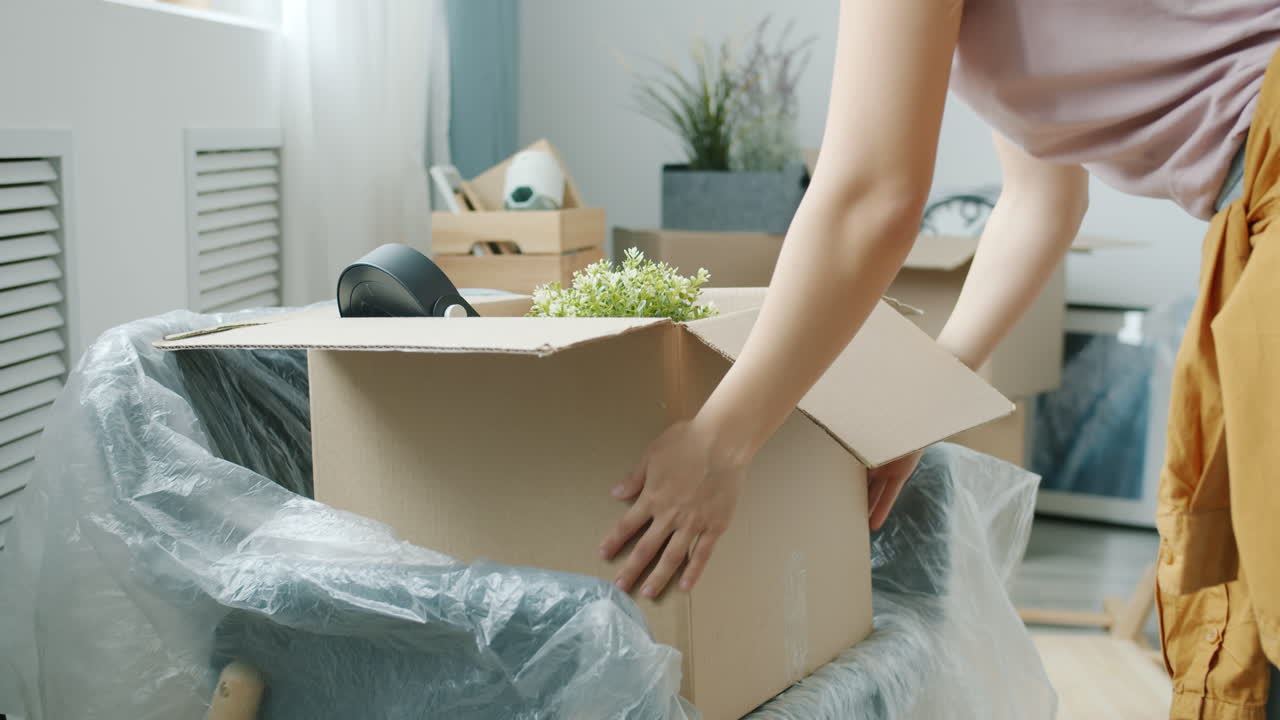 Woman Moving House Packing Boxes