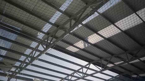 workers put up panels in the construction of the roof of an industrial building