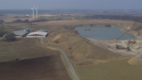 Aerial-view-of-a-tractor-driving-over-a-fled