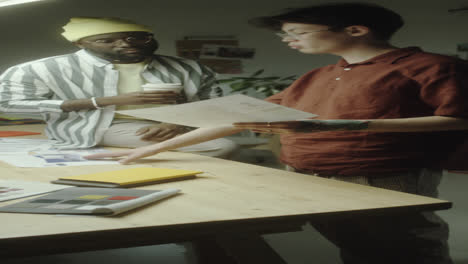 two diverse men collaborating on a design project in an office