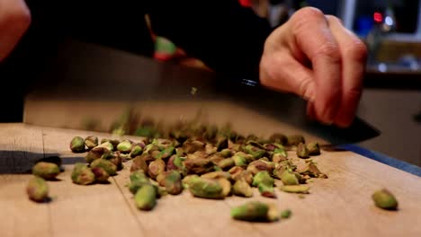 A-person-cuts-some-peanuts-with-a-large-knife