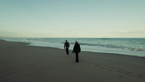A Walk Together on the Beach on Father's Day Near The Ocean At Susnet
