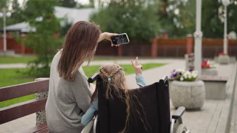 Mutter-Macht-Lustige-Selfies-Mit-Ihrer-Kleinen-Tochter-Im-Rollstuhl