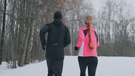 Happy-young-couple-married-sports-morning-and-evening-jogging-in-the-park.