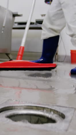 butcher cleaning floor