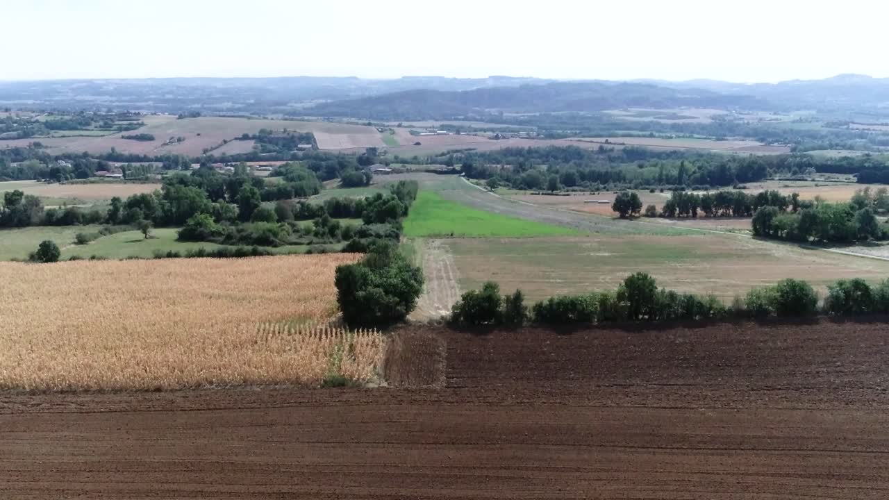 Aerial drone shot of farming land and small village in France