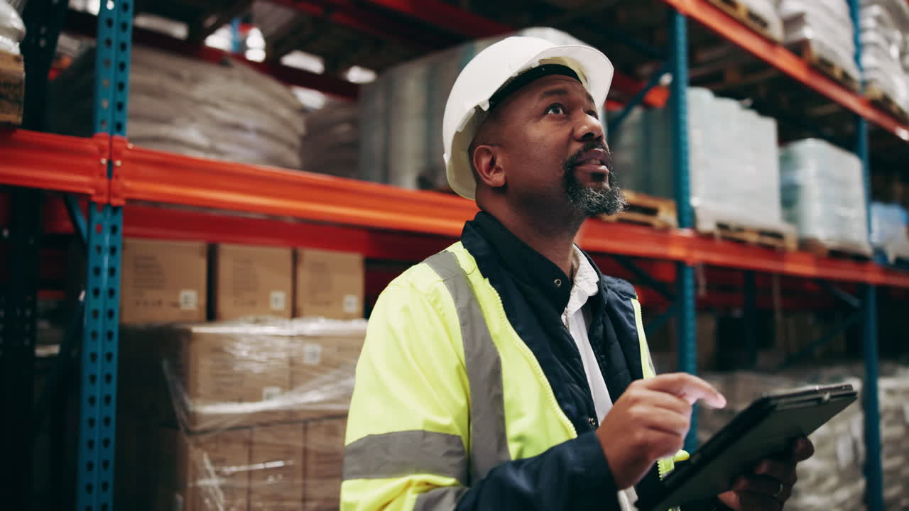 Warehouse worker wearing a hard hat and safety vest
