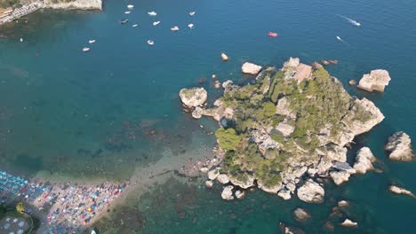 spectacular drone shot above isola bella in sicily, italy