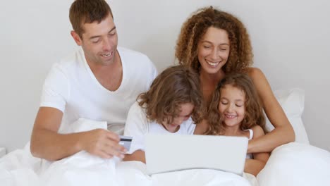 Happy-family-using-laptop