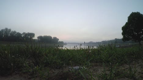 Beautiful-morning-on-a-relaxing-lake-as-the-fog-rolls-on-by-