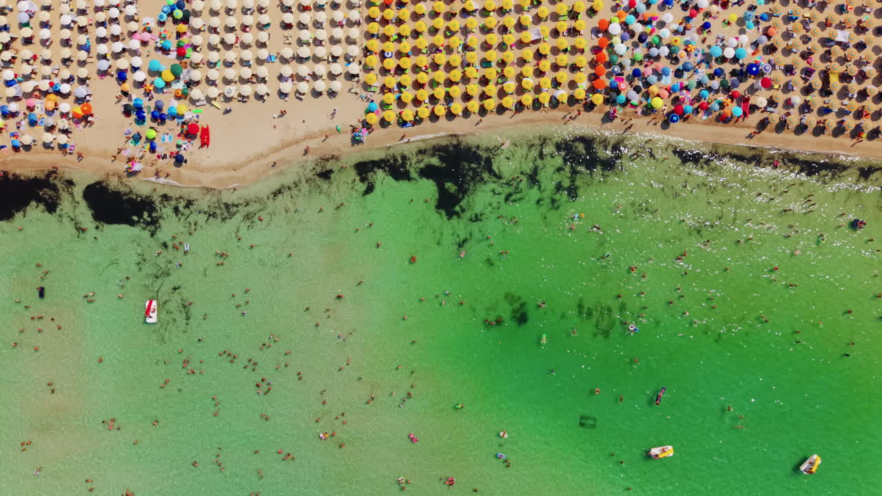 Aerial view of vibrant beach umbrellas in San Vito Lo Capo, Sicily