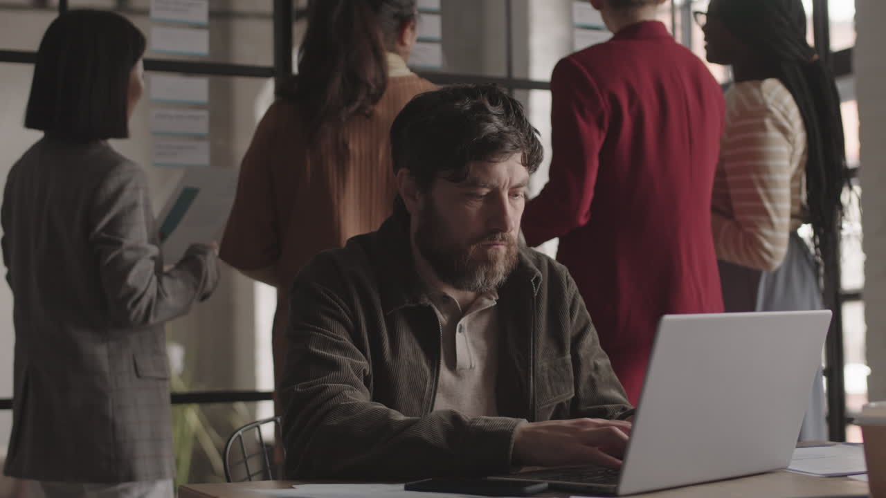 Caucasian Man Using Laptop in Office