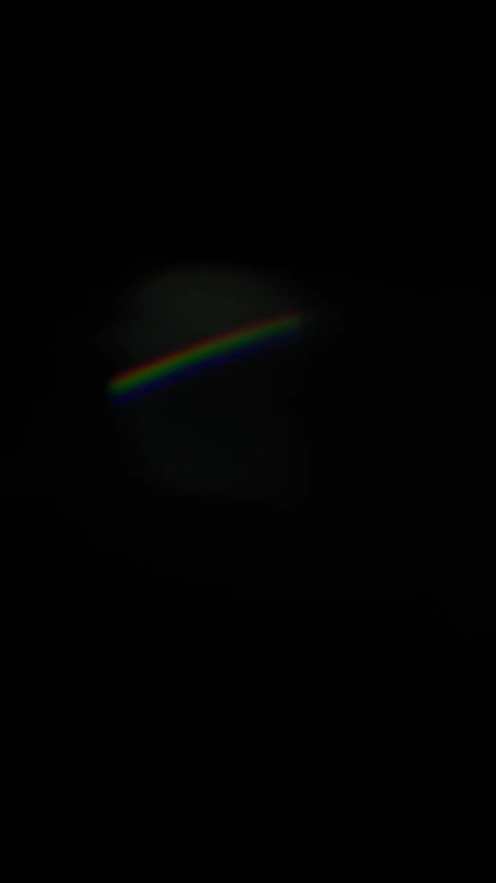 Light leaks and glass prism refractions in slow motion. Vertical Format
