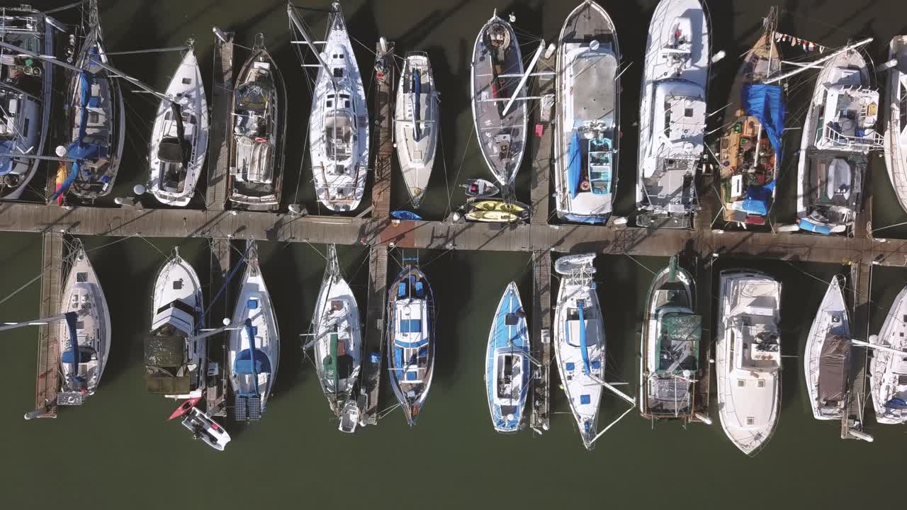 Moss Landing Marina - California, USA. Cinematic top down track left over yachts. Filmed on DJI Mavic Pro.