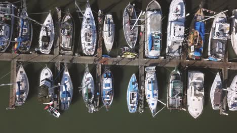 moss landing marina - california, usa. cinematic top down track left over yachts. filmed on dji mavic pro.