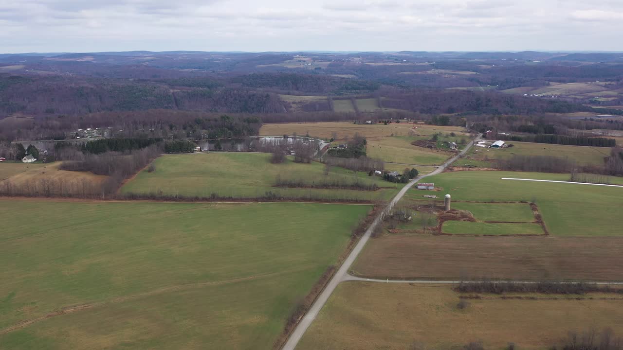 Aerial view above the rural road in the countryside, view of the campground by the Pine Cradle Lake in Rome Bradford County Pennsylvania, Agricultural Field, Panoramic Landscape