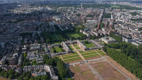 Slide-and-pan-footage-of-historic-buildings-of-Royal-Hospital-Chelsea-and-surrounding-parks-and-gardens.-Aerial-panoramic-view-of-urban-district.-London,-UK