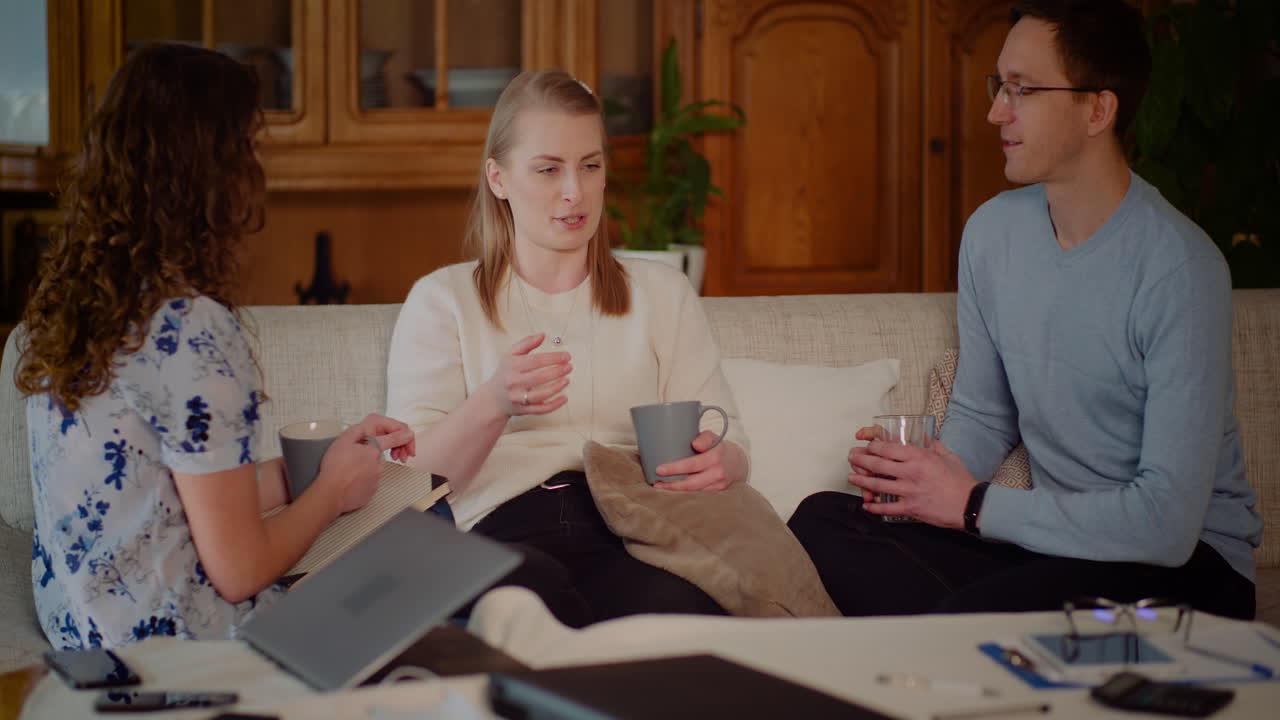 Group of Young Adults Having a Casual Discussion on a Couch