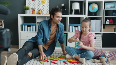 father and daughter playing with building blocks