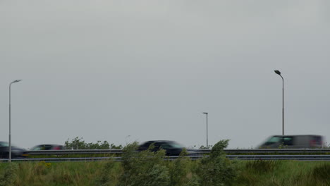 cars driving on a highway on an overcast day