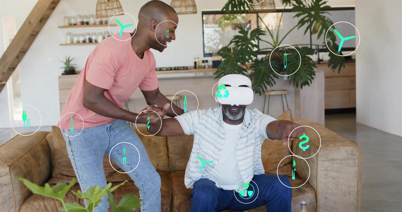 Adult son placing hand, guiding elder from sofa into standing, enabling VR use with green icons