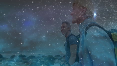 couple hiking on rocky coast at dusk, featuring snowflake animations and star flares for technology