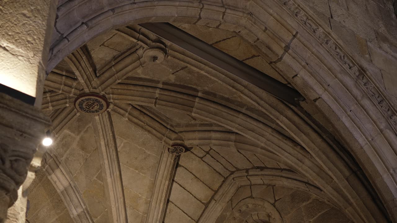 arched stone ceiling with gothic rib vault details in warm lighting
