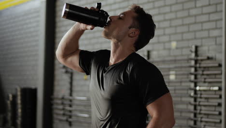 man resting after intense workout in gym