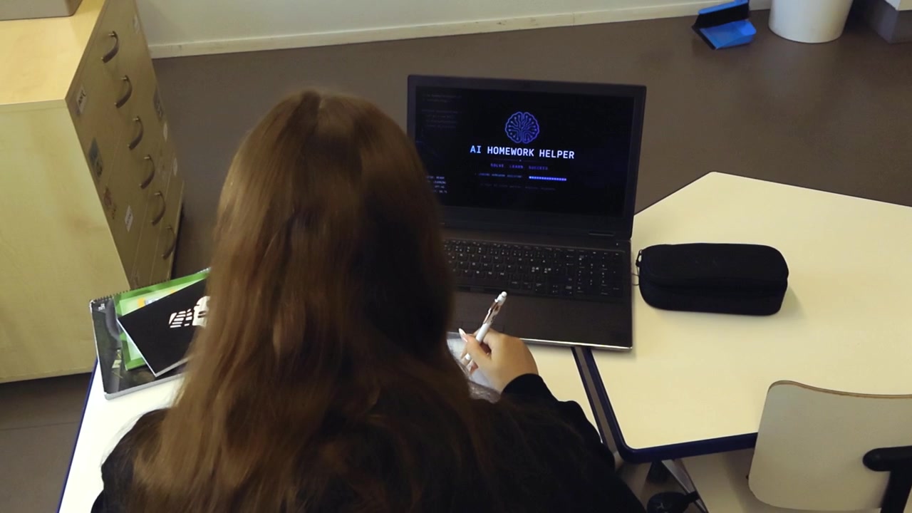 Female student sitting at her desk in a classroom while using an AI powered software on her laptop to get help with homework, showing the future of education and advanced learning technology