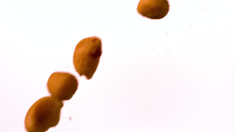 corn kernels pouring against white background