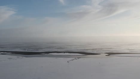snow covering black basalt beach in iceland