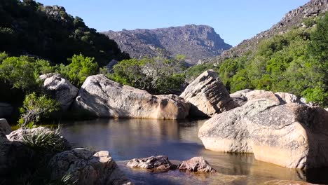 a beautiful lake oasis in the windy mountain shrubbery in southern africa