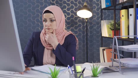 office worker in hijab is thoughtful.