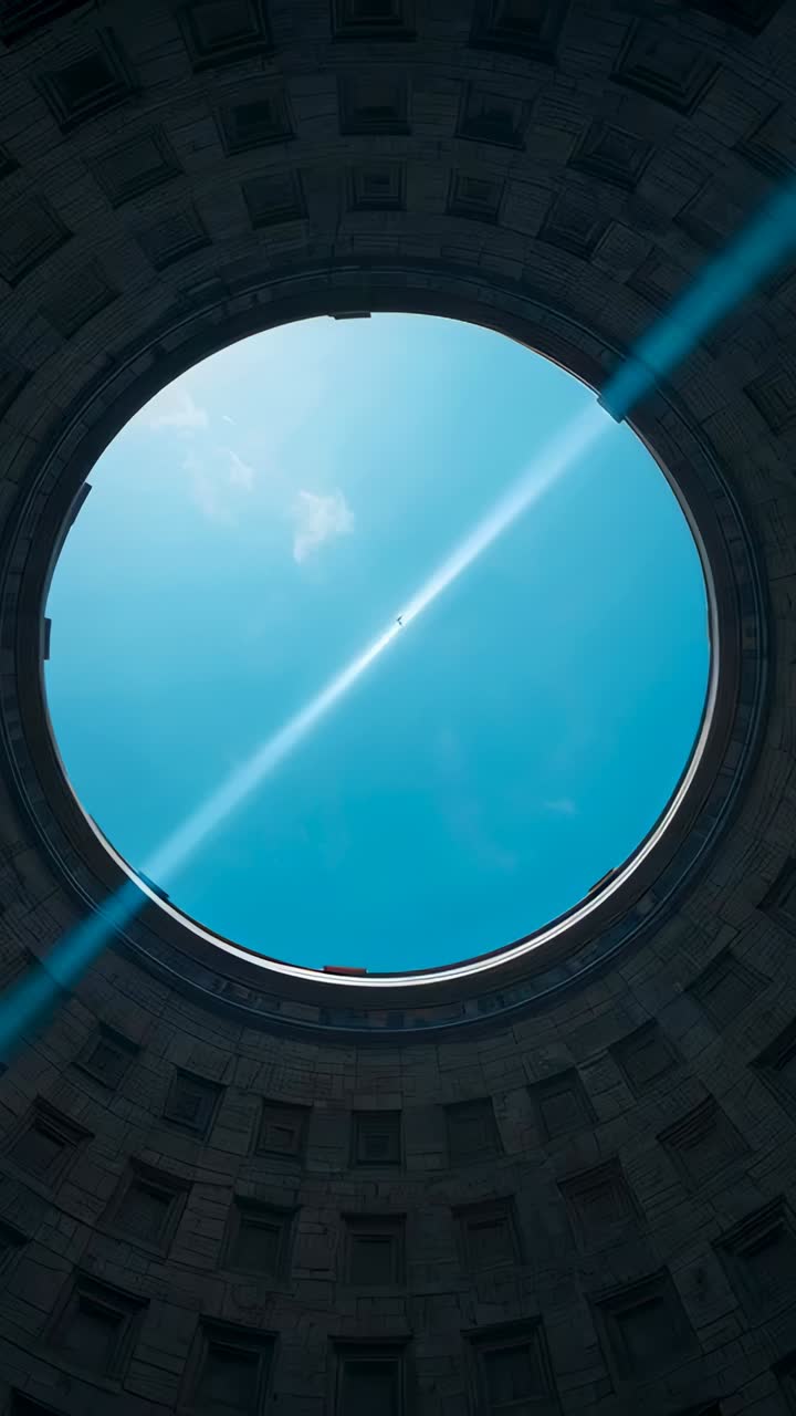 Vertical video: Tilting camera revealing oculus and coffered dome at rotunda, showing lens flare