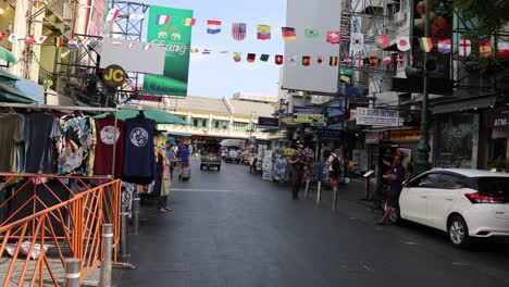 pedestrians and vehicles moving through a busy street