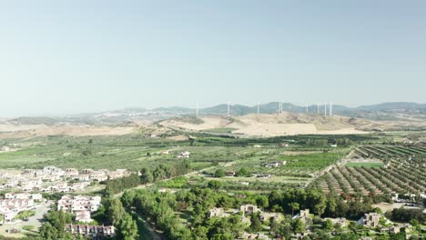 aerial view of the calabrian hinterland, olive fields and wind turbines in the background, calabria, italy