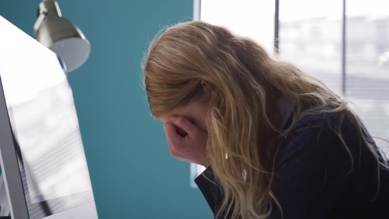 Caucasian woman tired at the office