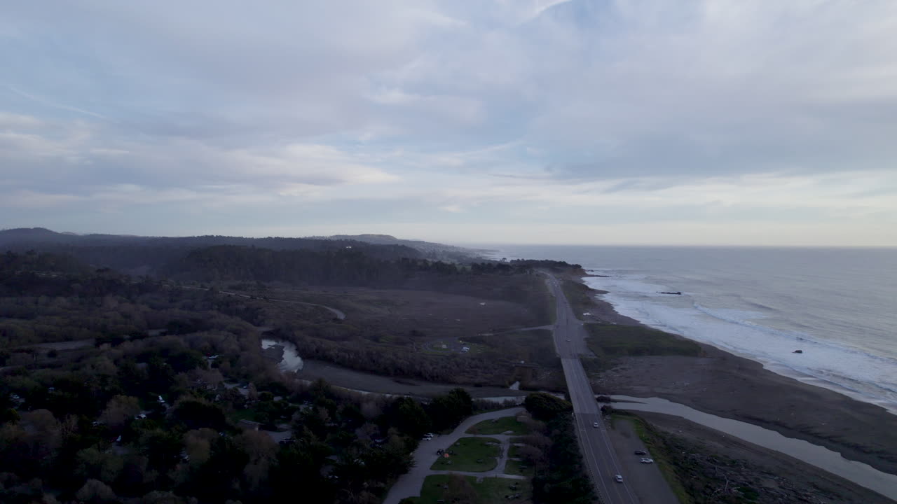 Scenic Highway 1 Winds Past Beaches, Coastal Cliffs, and Trails Near Cambria and San Simeon, California - Drone Flying Forward