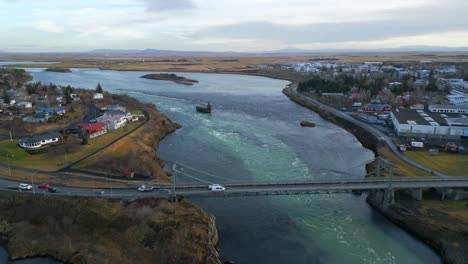 route 1 crossing olfusa river bridge in selfoss, iceland - aerial